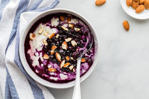 A yoghurt bowl with protein powder, berries and nuts