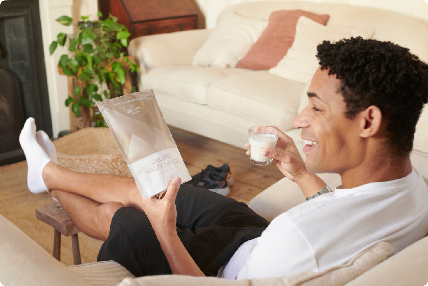 A man with a glass of whey protein shake